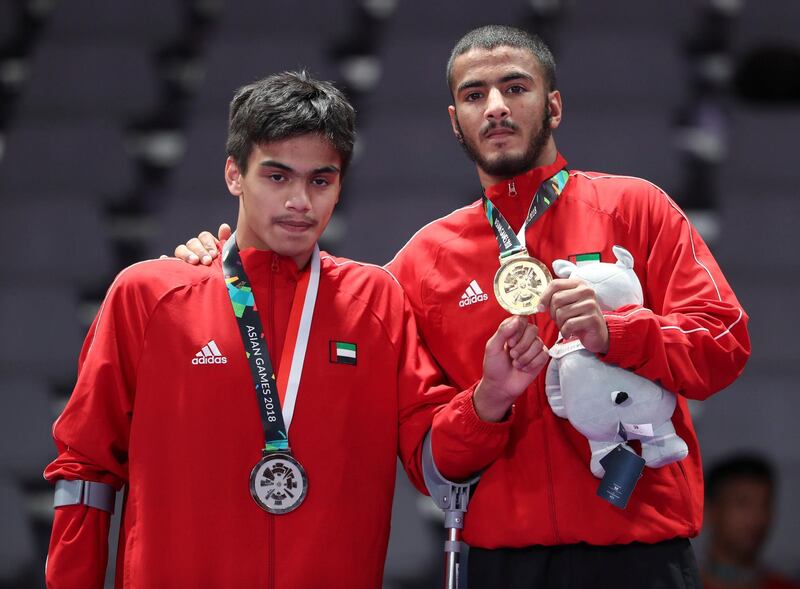 Gold medalist Hamad Nawad (R) of United Arab Emirates poses with Silver medalist Khalid Alblooshi of United Arab Emirates during the medal ceremony after the men's 56 kg Ju-Jitsu Gold Medal Match at the 18th Asian Games Jakarta. EPA