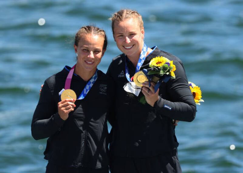 Gold medalists Lisa Carrington and Caitlin Regal of Team New Zealand celebrate at the medal ceremony for the Women's Kayak Double 500m Final.
