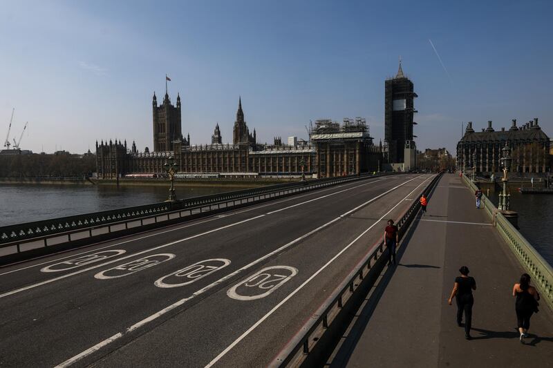 Pedestrians cross Westminster Bridge in view of the Houses of Parliament in London, U.K., on Thursday, April 9, 2020. U.K. Prime Minister Boris Johnson spent a third night in the critical care unit where his condition is improving, as officials draw up plans to extend the lockdown in an bid to control the U.K.’s growing coronavirus crisis. Photographer: Simon Dawson/Bloomberg