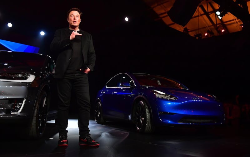Mr. Musk speaks beside the just unveiled new Tesla Model Y. AFP