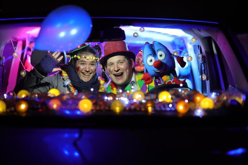 Guests, dressed in carnival costumes, listening in their car to the German band CatCar – Cat Ballou, who were performing a drive-in concert in Cologne, Germany. Getty Images