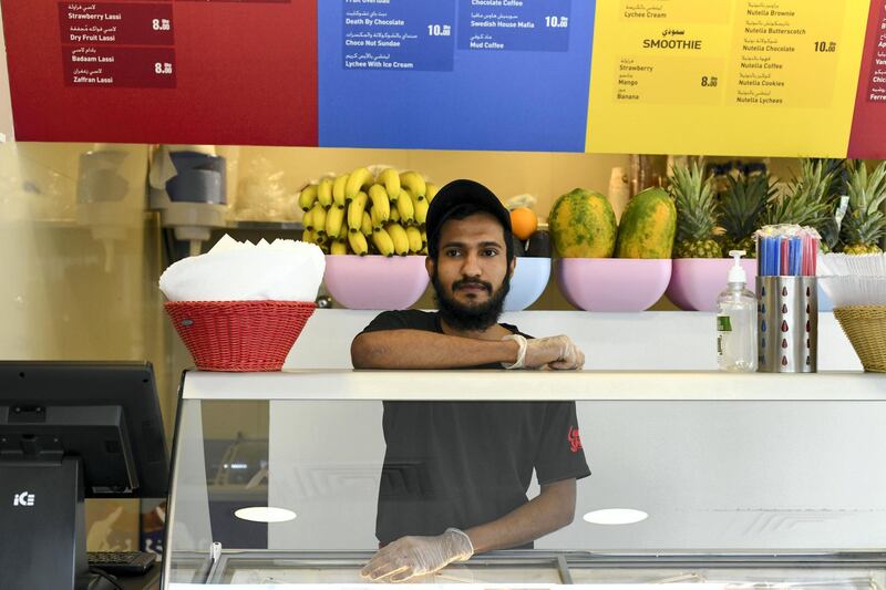 Abu Dhabi, United Arab Emirates - Manor Mohammed, 23, originally from India works at a milkshake cafe in Tourist Club Area for a year and a half. Khushnum Bhandari for The National