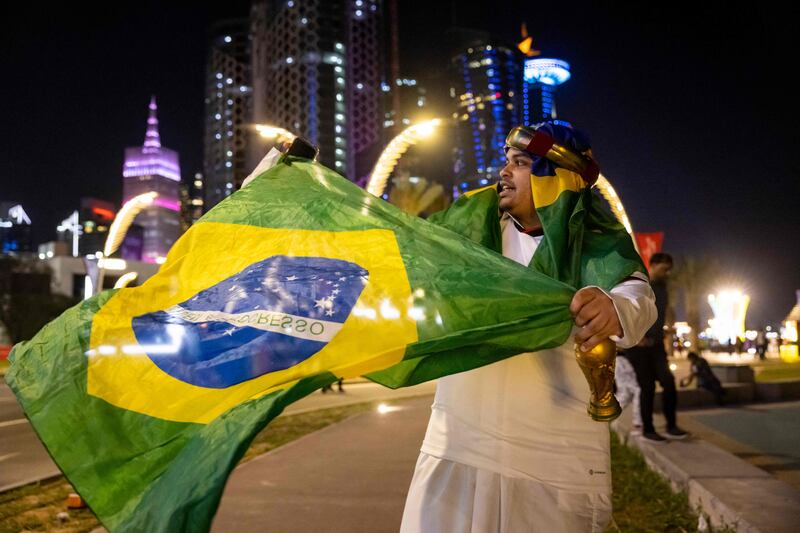 A fan waves the Brazilian national flag in Doha, during the opening day of the Qatar 2022 World Cup. AFP