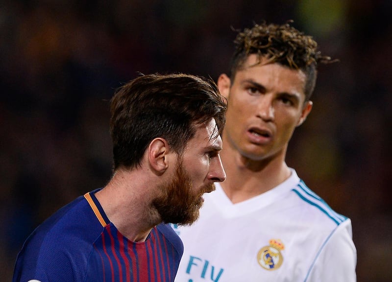 TOPSHOT - Real Madrid's Portuguese forward Cristiano Ronaldo (R) looks at Barcelona's Argentinian forward Lionel Messi during the Spanish league football match between FC Barcelona and Real Madrid CF at the Camp Nou stadium in Barcelona on May 6, 2018. / AFP PHOTO / Josep LAGO