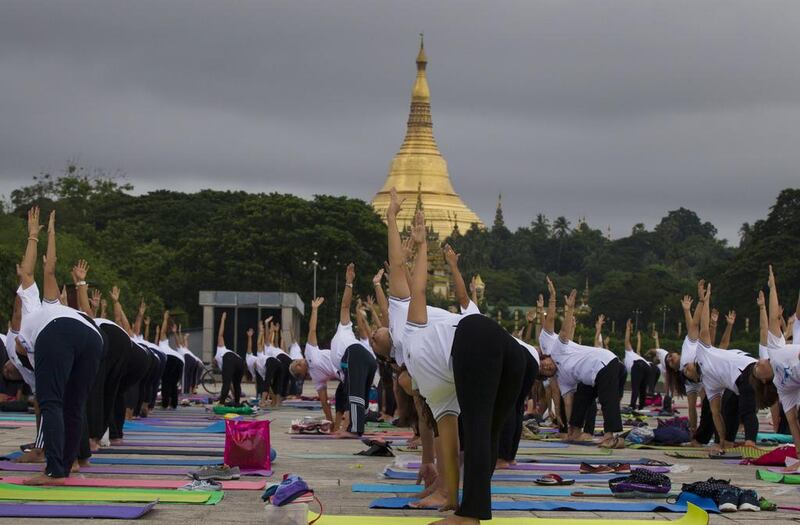 People practice yoga on International Yoga Day, in front of Shwedagon pagoda in Yangon, Myanmar. Thein Zaw / AP photo