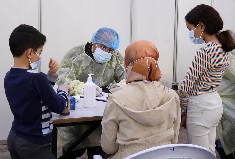 Expatriate returning from Egypt, Syria, and Lebanon arrive to be re-tested at a Kuwaiti health ministry containment and screening zone for COVID-19 coronavirus disease in Kuwait City on March 16, 2020. Facing a mounting public health threat, Saudi Arabia, the United Arab Emirates, Kuwait, Bahrain, Qatar and Oman have taken drastic measures to combat the pandemic. Kuwait has taken the strictest measures in the GCC by largely locking down the country over the weekend. / AFP / YASSER AL-ZAYYAT
