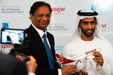 SpiceJet chairman and managing director Ajay Singh, left, and Sheikh Khalid Bin Saud Al Qasimi, vice chairman of RAK's Investment and Development Office. India's low-cost airline SpiceJet said it would use now-grounded 737 Max aircraft at its new hub in the UAE once regulators approve the planes for flight. AP  