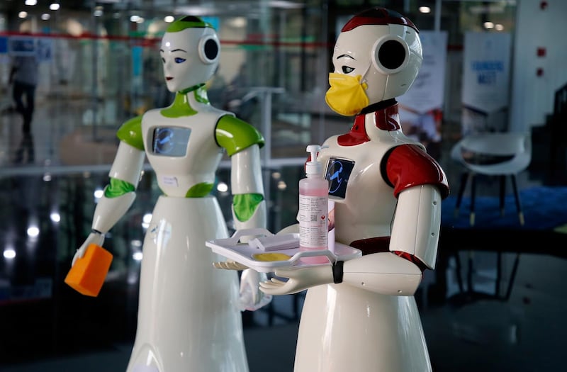 A robot, developed by a start-up firm Asimov Robotics, holds a tray with face masks and sanitiser in Kochi. Reuters