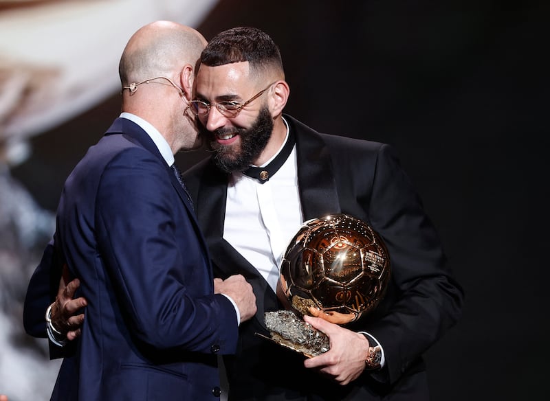 Real Madrid's Karim Benzema hugs former Real Madrid manager Zinedine Zidane after winning the Ballon d'Or with former player and manager Zinedine Zidane. Reuters