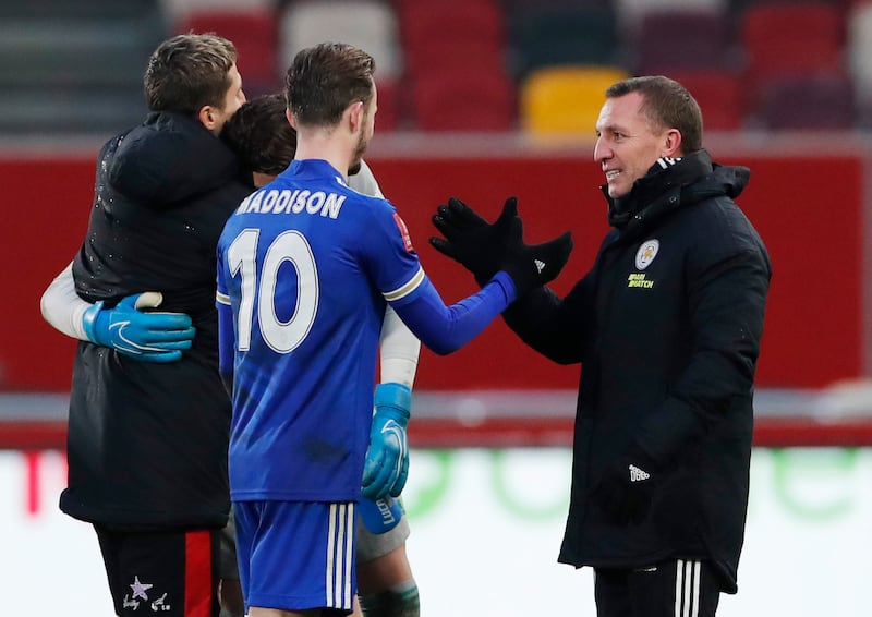 Leicester City manager Brendan Rodgers celebrates with James Maddison after the match. Reuters