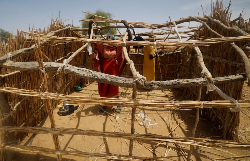 Sudanese refugee women build a makeshift shelter in Koufroun, Chad. Reuters