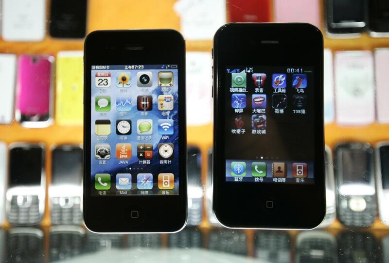 Two different fake iPhones are shown at a mobile phone market in the Chinese city of Shanghai. Apple is one of the most popular brands in China, where authorities have stepped up efforts in recent years to dispel the country’s reputation for turning out counterfeit goods. AP Photo