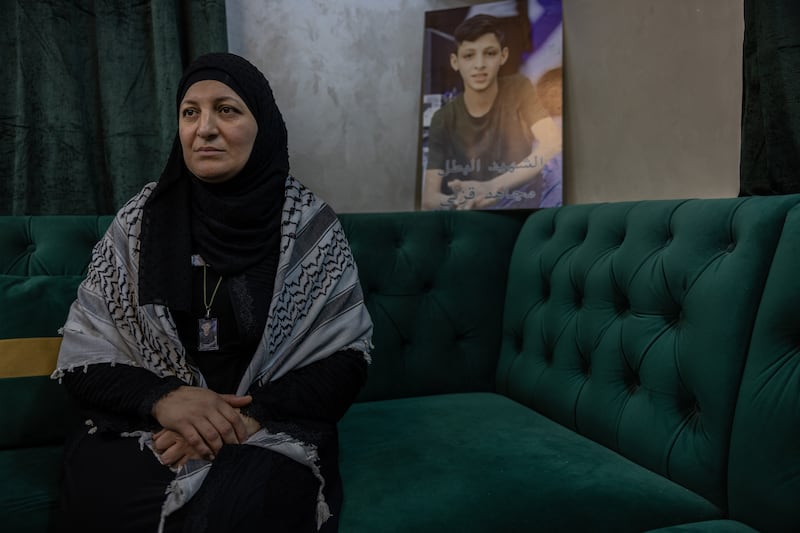 Abier Shole, 42, lost her son Mujahid, 16, in an Israeli strike in Nur Shams refugee camp. 'He was just a child,' she says. 'What happened to me is still easier to process compared to what is happening to people in Gaza.' She carries around her neck a copy of the poster of her son on the wall behind her