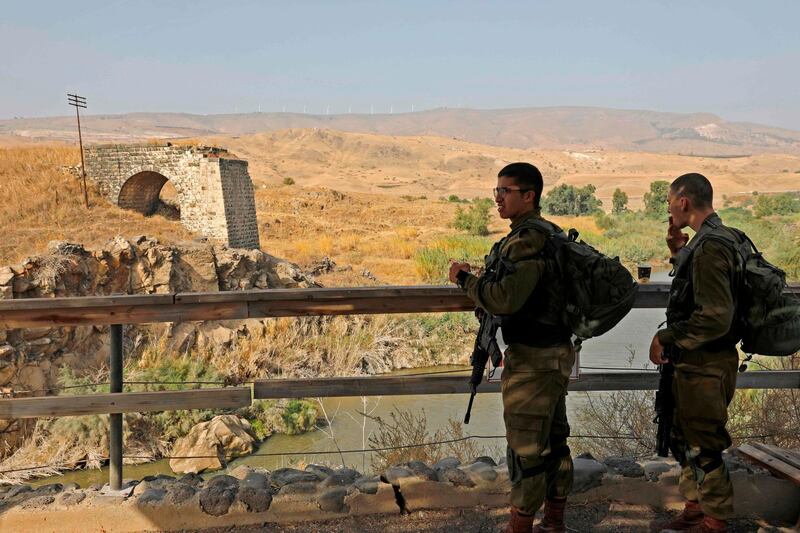 Israeli soldiers patrol the border fence in Baqura. AFP