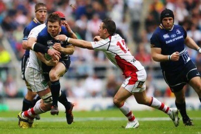 Leinster's Brian O'Driscoll is tackled by two Ulster players during the Heineken Cup final, which Leinster won.