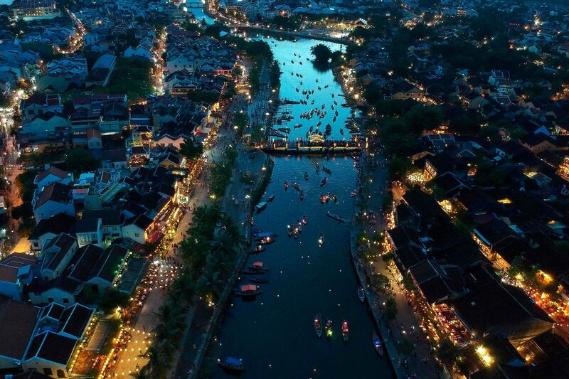 In this aerial picture people gather to release paper-lanterns for good luck during the mid-autumn festival down the Thu Bon river in the old quarters of Hoi An, a UNESCO world heritage site. AFP