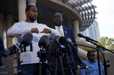 Astroworld Festival attendee Dishon Isaac speaks during a press conference as lawyer Ben Crump looks on. AFP