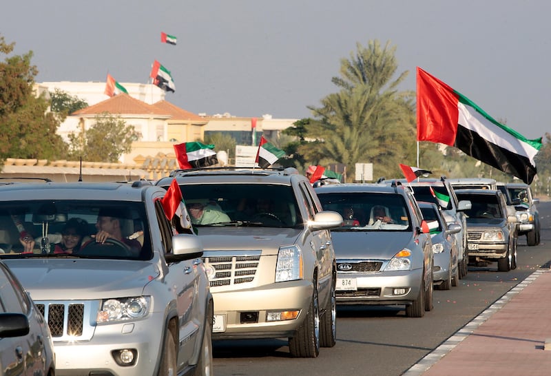 Umm Al Quwain, United Arab Emirates - December 2, 2013.  Cars parade which participated by more than a hundred cars started near the Clock roundabout in celebration of the 42nd UAE National Day.  ( Jeffrey E Biteng / The National )  Editor's Note;  Kyle S reports. *** Local Caption ***  JB021213-Natlday05.jpg