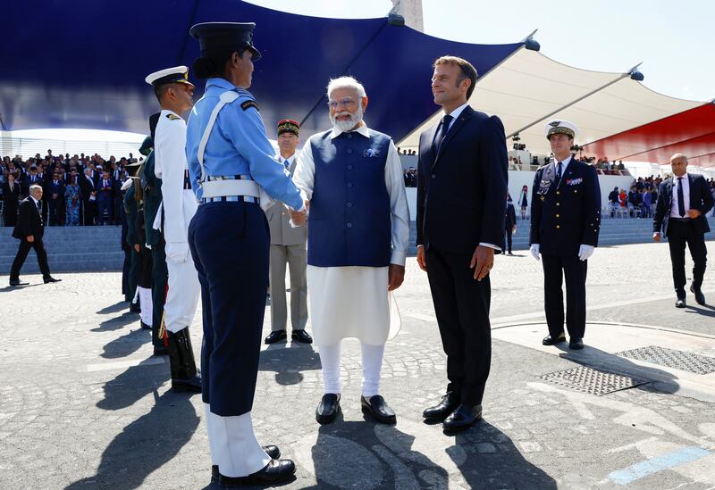 Mr Modi shakes hands with an Indian soldier during the military parade. AP