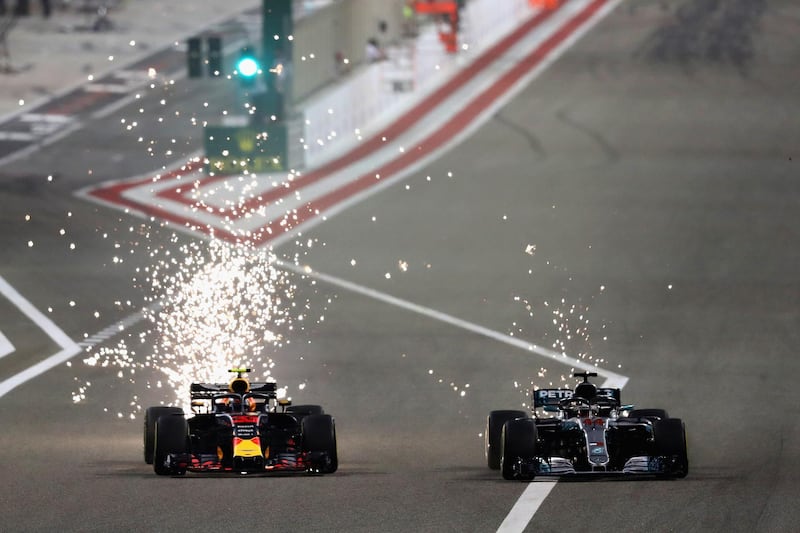 BAHRAIN, BAHRAIN - APRIL 08:  Sparks fly behind Max Verstappen of the Netherlands driving the (33) Aston Martin Red Bull Racing RB14 TAG Heuer and Lewis Hamilton of Great Britain driving the (44) Mercedes AMG Petronas F1 Team Mercedes WO9 on track during the Bahrain Formula One Grand Prix at Bahrain International Circuit on April 8, 2018 in Bahrain, Bahrain.  (Photo by Lars Baron/Getty Images)