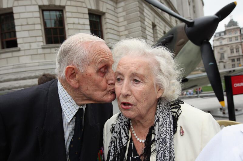 LONDON, ENGLAND - AUGUST 20: A Battle of Britain Veteran kisses Dame Vera Lynn in front of a Mark IV Supermarine Spitfire replica, owned by the Imperial War Museum outside the Churchill War Rooms museum as part of the Battle of Britain anniversary celebration on August 20, 2010 in London, England. This year commemorates the 70th Anniversary of the Battle of Britain.  (Photo by Dan Kitwood/Getty Images)