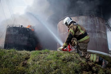 A firefighter working to extinguish a fire at an oil depot in the Smolensk region in Russia. AFP