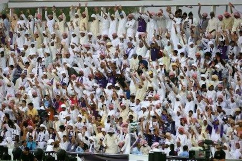 Fans cheer at Pro League match between Al Ain and Ajman. Pawan Singh / The National