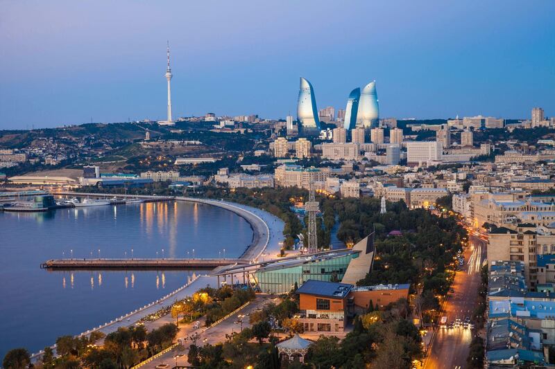 Azerbaijan, Baku, View of city looking towards The Baku Business Center on the Bulvur - waterfront in the distance are  Flame Towers and TV tower. Getty Images