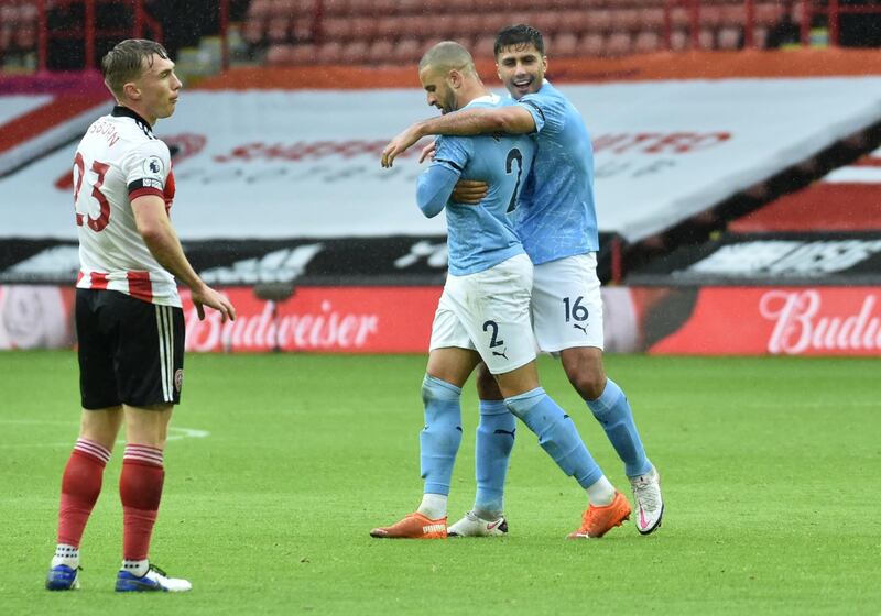 Manchester City's Kyle Walker celebrates scoring with Rodrigo. Reuters