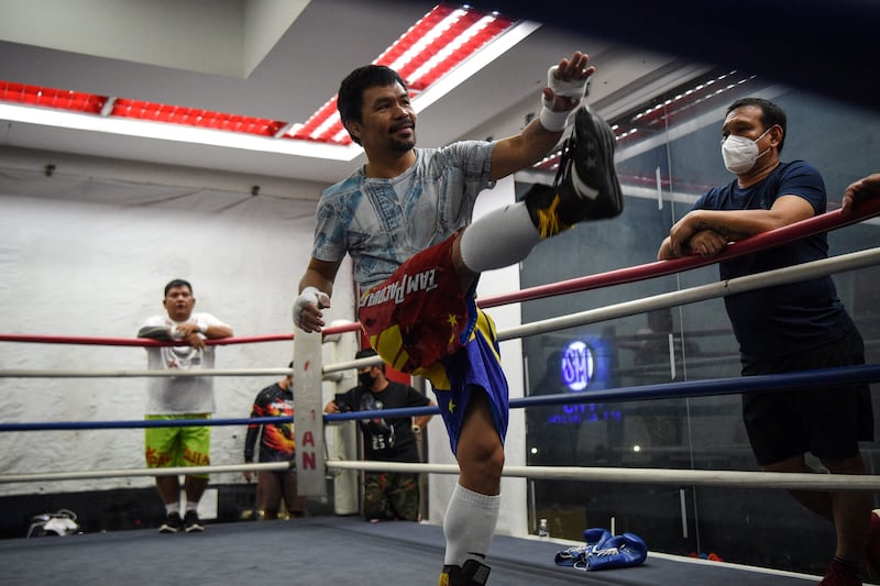 This photo taken on June 22, 2021 shows Philippine boxing legend and Senator Manny Pacquiao (C) training at his gym in the city of General Santos in southern island of Mindanao for his upcoming bout against Errol Spence of the US.  - A two-year break from boxing has left Philippine legend Manny Pacquiao "hungry" to get back in the ring for what could be the last fight of his storied career -- and a warm-up for a presidential rumble.  (Photo by TED ALJIBE  /  AFP)  /  TO GO WITH STORY by Allison JACKSON