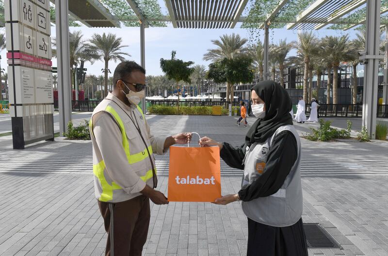 An employee of the Food Bank gives a man a food package.