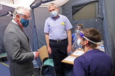 The Prince of Wales meets with NHS staff during a visit to a vaccination centre at Gloucestershire Royal Hospital. AFP.