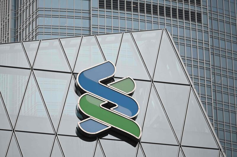 A general view shows a logo displayed on a branch of the Standard Chartered Bank in Hong Kong on February 26, 2019. Standard Chartered's fortunes climbed in 2018 to 3.9 billion USD in pre-tax profits the bank said, after previously warning it had set aside nearly a billion dollars for regulatory fines in the United States and Britain. / AFP / Sam YEH
