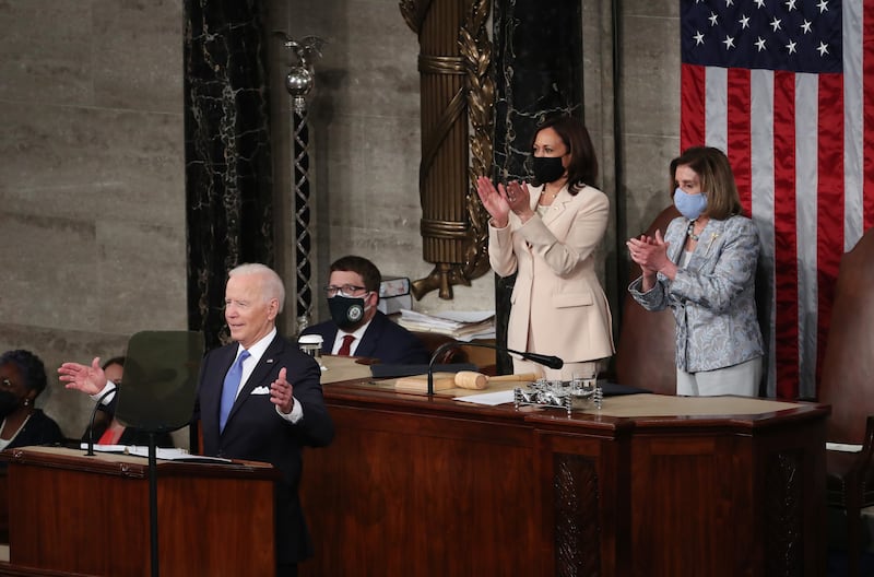 Mr Biden delivers his first address to a joint session of Congress on April 28 as Ms Harris, second right, and speaker of the United States House of Representatives Nancy Pelosi applaud. EPA