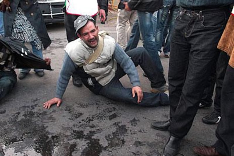 A man reacts to five fellow protesters setting themselves alight in the Moroccan capital Rabat on Wednesday. The self-immolation attempts came during a protest over a lack of jobs.