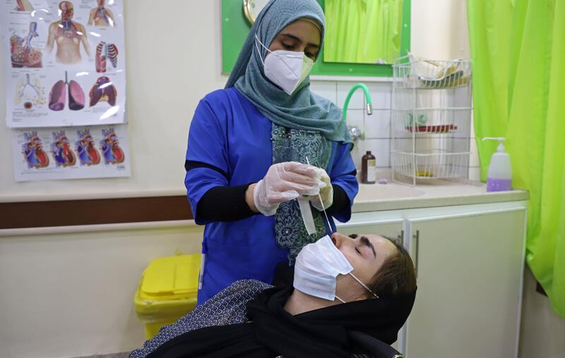 An Iraqi Kurdish woman is tested for Covid-19 at a hospital in the northeastern city of Sulaymaniyah in Iraq's autonomous Kurdistan region, which has seen the hights death rates from the novel coronavirus. The virus has hit hard Iraq which more than 375,000 people infected and some 9,500 deaths.  AFP