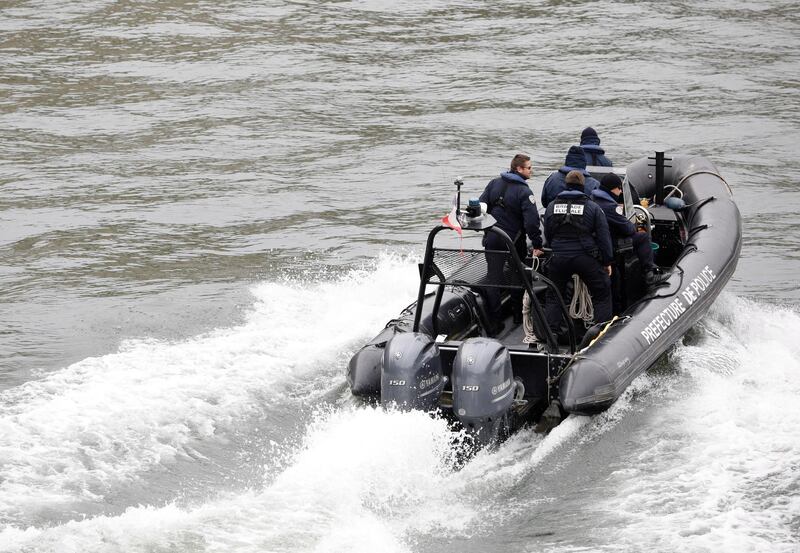 Police officers patrol in a rubber boat on the Seine river. AP Photo