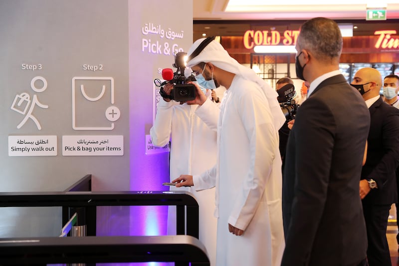 Omar Sultan Al Olama, UAE Minister of State for Artificial Intelligence, scanning the bar code on his phone to enter the Carrefour City+ store at Mall of the Emirates in Dubai on September 6, the day of the store's launch. Pawan Singh / The National