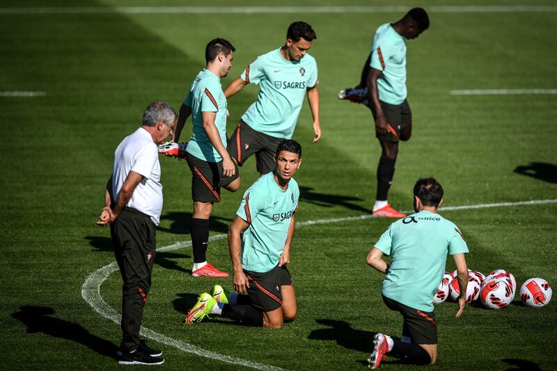 Portugal's Cristiano Ronaldo with manager Fernando Santos and teammates at training. AFP