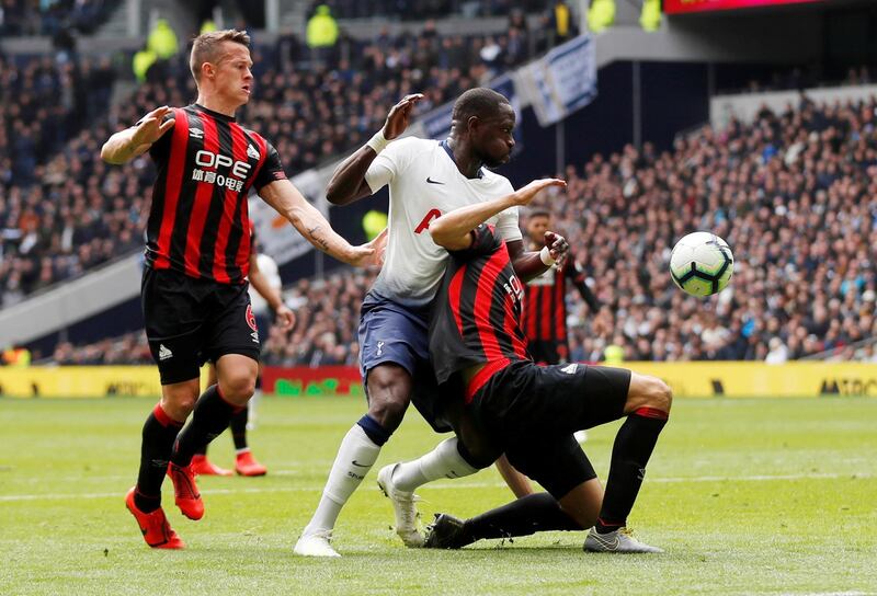 Tottenham's Moussa Sissoko in action with Huddersfield Town's Jon Gorenc Stankovic and Jonathan Hogg. Reuters