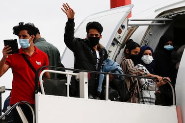 The refugees waved as they boarded the flight to be reunited with their families who had made it to the UK. EPA