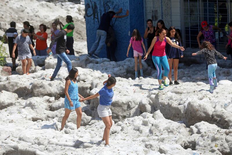 Residents play on top of ice after a heavy storm of rain and hail which affected Guadalajara, Mexico. Reuters