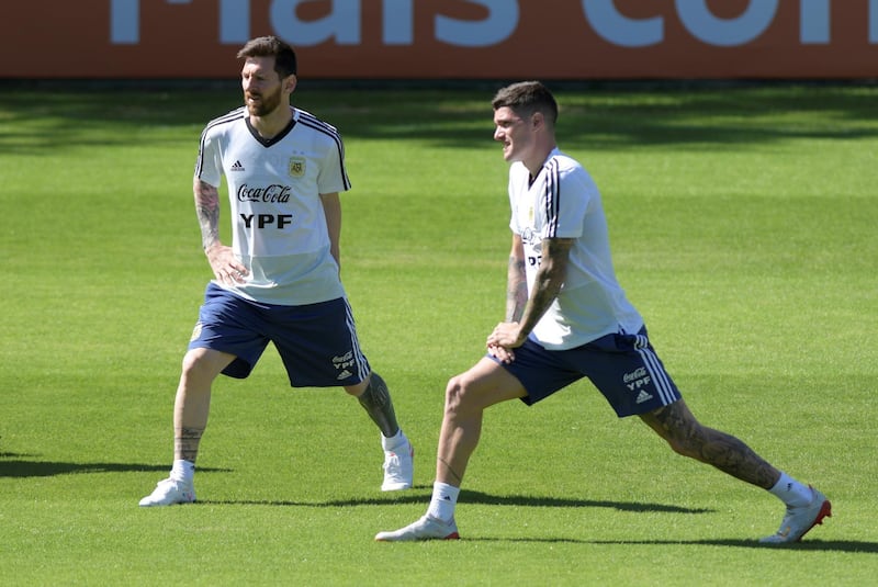 Argentina's Lionel Messi, left, stretches during training. Reuters