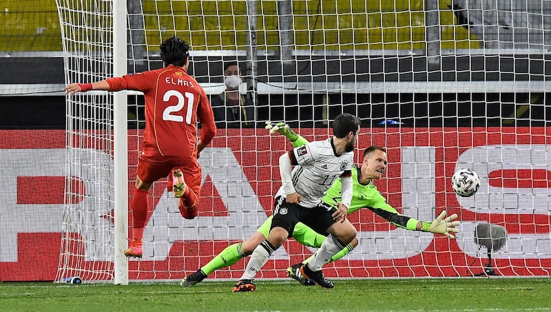 North Macedonia's Eljif Elmas, left, scores the decisive second goal for his side against Germany's keeper Marc-Andre ter Stegen during the World Cup 2022 group J qualifying soccer match between Germany and North Macedonia in Duisburg, Germany, Wednesday, March 31, 2021. (AP Photo/Martin Meissner)