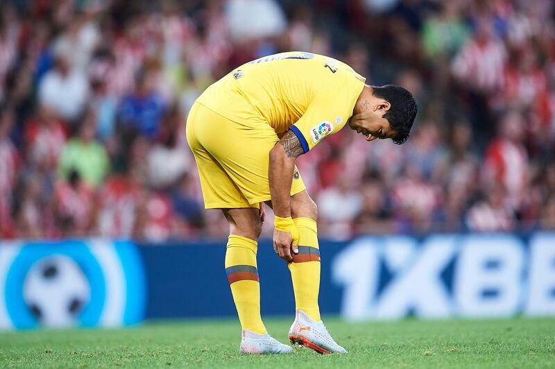 BILBAO, SPAIN - AUGUST 16: Luis Suarez of FC Barcelona touches his calf  during the Liga match between Athletic Club and FC Barcelona at San Mames Stadium on August 16, 2019 in Bilbao, Spain. (Photo by Juan Manuel Serrano Arce/Getty Images)