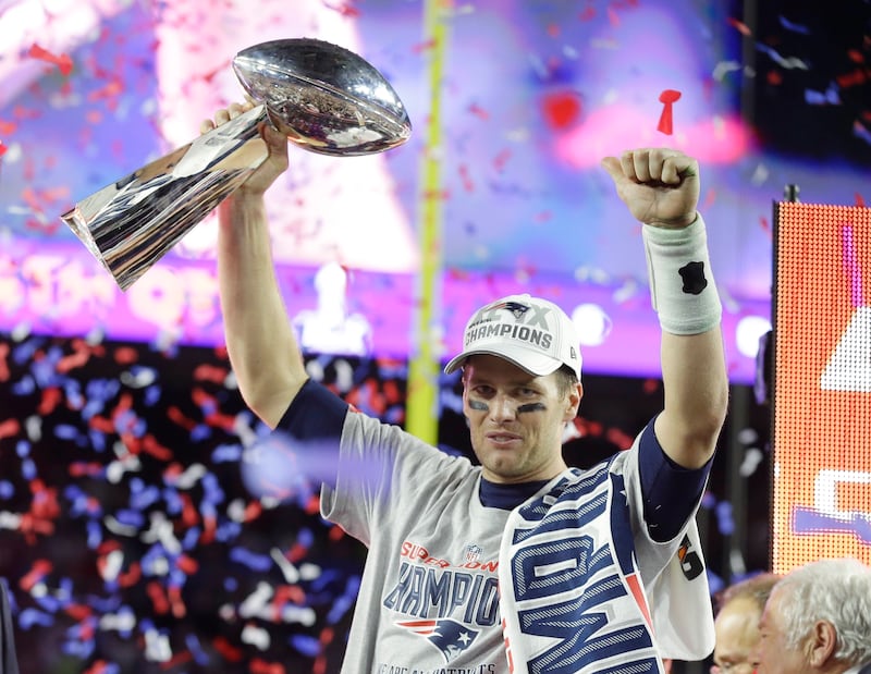 New England Patriots quarterback Tom Brady celebrates with the Vince Lombardi Trophy after the NFL Super Bowl victory over the Seattle Seahawks in 2015. The Patriots won 28-24. AP