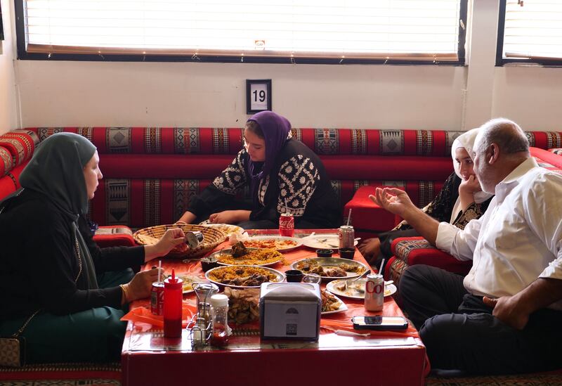 Diners at the House of Mandi at traditional floor seating. Photo: Steve LaBate