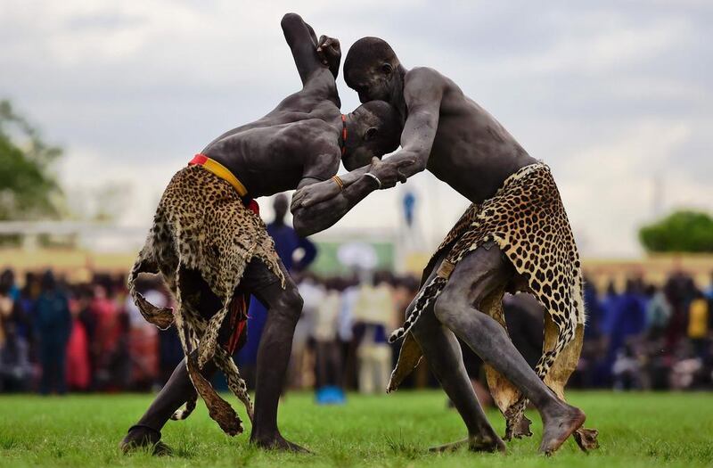 Wrestlers from Jonglei and eastern lakes region take part in the South Sudan national wrestling competition for peace at Juba stadium, South Sudan, on April 20, 2016.  South Sudan is holding a “wrestling for peace” tournament, bringing together athletes from around the country. Carl de Souza/AFP