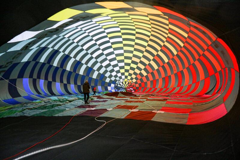 Participants prepare their hot air balloons at the Flutuar - III Coruche Ballooning Festival, in Coruche, Portugal.   EPA