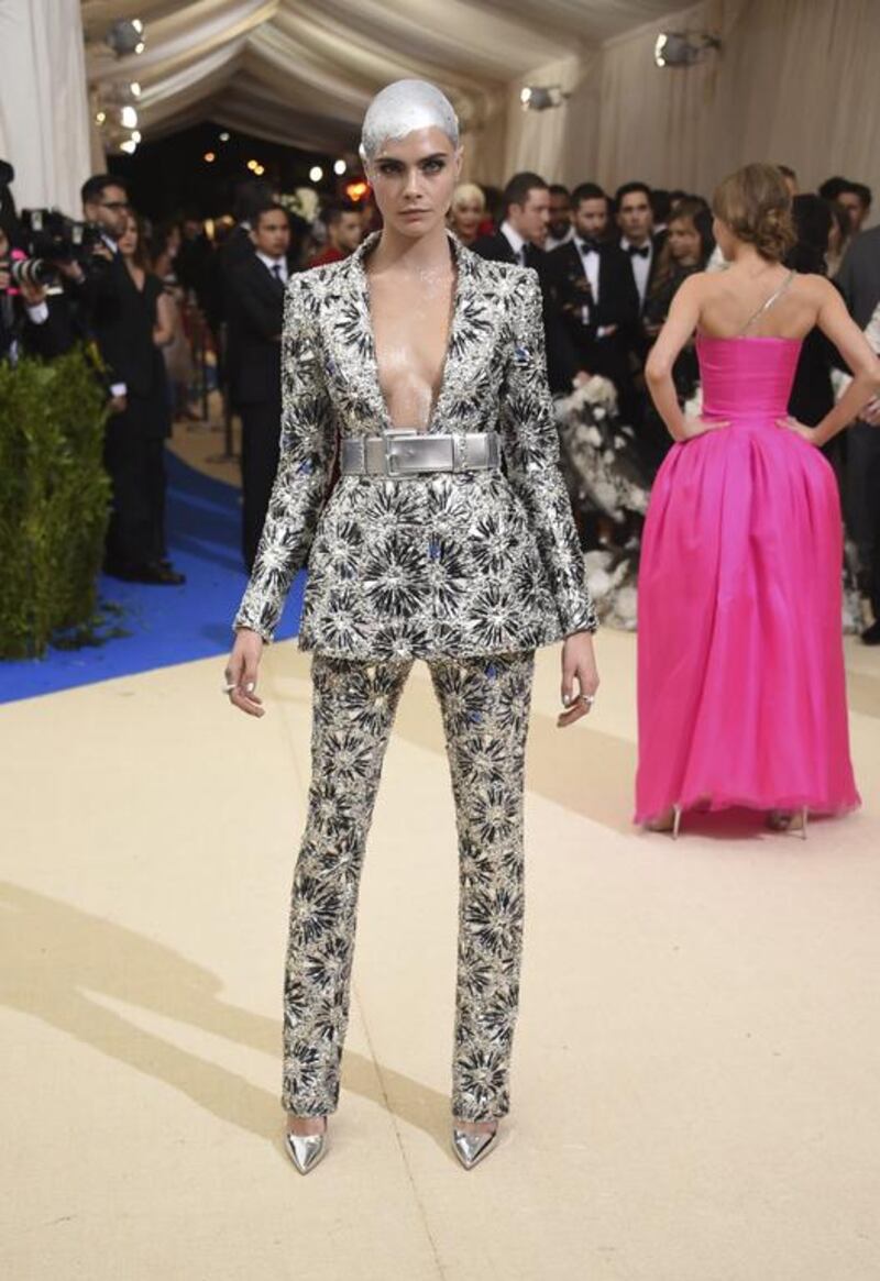 Dressed in Chanel Couture, Cara Delevingne debuted her silver-painted shaved head on the red carpet. Evan Agostini / Invision / AP